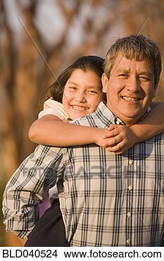 Stock Photo - hispanic father 
giving daughter 
piggyback ride. 
fotosearch - search 
stock photos, 
pictures, images, 
and photo clipart