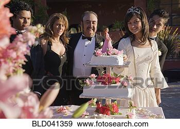 Stock Photograph - hispanic girl 
cutting cake at 
quinceanera. fotosearch 
- search stock 
photos, pictures, 
images, and photo 
clipart