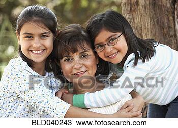 Stock Photo - hispanic grandmother 
and granddaughters 
hugging. fotosearch 
- search stock 
photos, pictures, 
images, and photo 
clipart