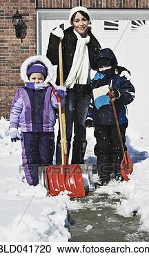 Stock Photography - hispanic mother 
and children shoveling 
snow. fotosearch 
- search stock 
photos, pictures, 
images, and photo 
clipart