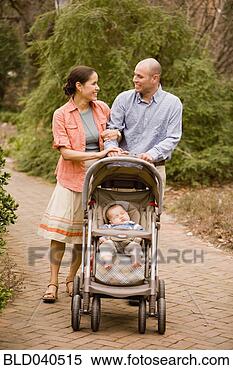 Stock Image - hispanic parents 
pushing baby in 
stroller. fotosearch 
- search stock 
photos, pictures, 
images, and photo 
clipart