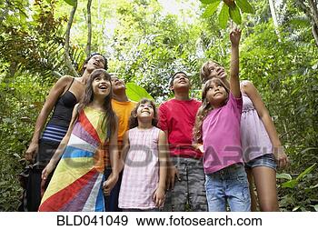 Stock Photograph - hispanic woman 
and children exploring 
woods. fotosearch 
- search stock 
photos, pictures, 
images, and photo 
clipart