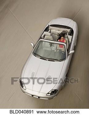 Stock Photography - hispanic woman 
driving convertible 
car. fotosearch 
- search stock 
photos, pictures, 
images, and photo 
clipart