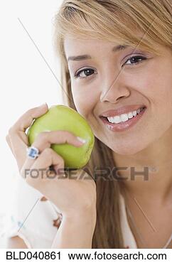 Stock Photography - hispanic woman 
eating apple. 
fotosearch - search 
stock photos, 
pictures, images, 
and photo clipart