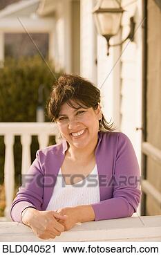 Stock Photography - hispanic woman 
leaning on porch 
railing. fotosearch 
- search stock 
photos, pictures, 
images, and photo 
clipart