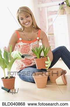 Stock Photo - hispanic woman 
potting plants. 
fotosearch - search 
stock photos, 
pictures, images, 
and photo clipart
