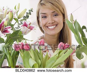 Stock Photo - hispanic woman 
surrounded by 
flowers. fotosearch 
- search stock 
photos, pictures, 
images, and photo 
clipart