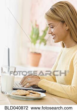 Stock Photo - hispanic woman 
typing on laptop. 
fotosearch - search 
stock photos, 
pictures, images, 
and photo clipart