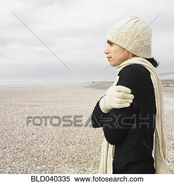 Stock Image - hispanic woman 
wearing hat and 
scarf on beach. 
fotosearch - search 
stock photos, 
pictures, images, 
and photo clipart