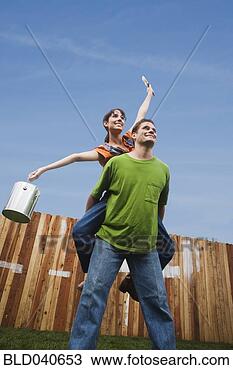 Stock Photo - man giving girlfriend 
piggyback ride. 
fotosearch - search 
stock photos, 
pictures, images, 
and photo clipart