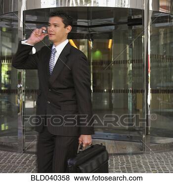 Stock Photo - mixed race businessman 
talking on cell 
phone. fotosearch 
- search stock 
photos, pictures, 
images, and photo 
clipart