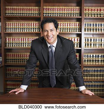 Stock Photography - mixed race male 
lawyer leaning 
on desk. fotosearch 
- search stock 
photos, pictures, 
images, and photo 
clipart