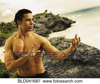 Picture - mixed race man 
practicing tai 
chi. fotosearch 
- search stock 
photos, pictures, 
images, and photo 
clipart