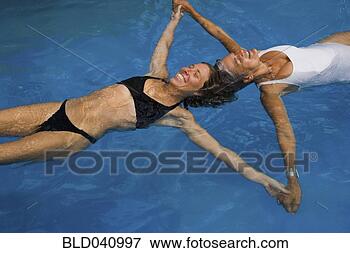 Picture - mother and adult 
daughter floating 
in swimming pool. 
fotosearch - search 
stock photos, 
pictures, images, 
and photo clipart