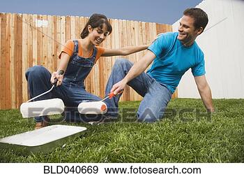 Stock Photograph - multi-ethnic couple 
painting fence. 
fotosearch - search 
stock photos, 
pictures, images, 
and photo clipart