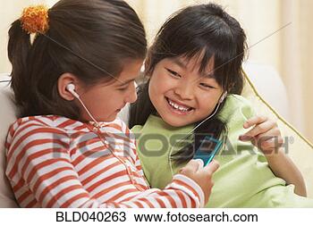 Stock Photo - multi-ethnic girls 
listening to same 
mp3 player. fotosearch 
- search stock 
photos, pictures, 
images, and photo 
clipart