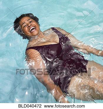 Stock Photo - senior mixed race 
woman in swimming 
pool. fotosearch 
- search stock 
photos, pictures, 
images, and photo 
clipart