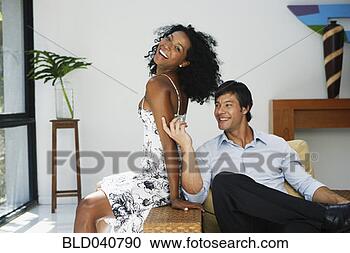 Stock Photography - south american 
couple sitting 
on chair. fotosearch 
- search stock 
photos, pictures, 
images, and photo 
clipart