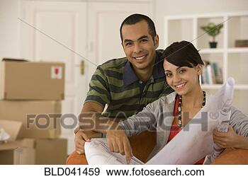 Stock Photograph - young couple looking 
at blueprints 
in new house. 
fotosearch - search 
stock photos, 
pictures, images, 
and photo clipart