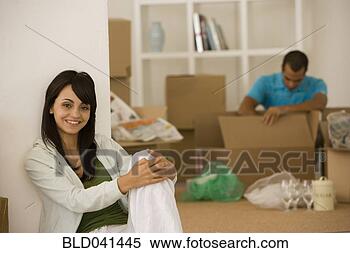 Stock Image - young couple unpacking 
boxes in new house. 
fotosearch - search 
stock photos, 
pictures, images, 
and photo clipart
