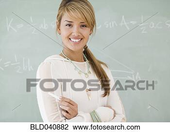 Stock Photo - young hispanic 
woman in front 
of blackboard. 
fotosearch - search 
stock photos, 
pictures, images, 
and photo clipart