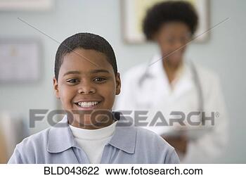 Stock Photo - african american 
boy smiling at 
doctor’s office. 
fotosearch - search 
stock photos, 
pictures, images, 
and photo clipart