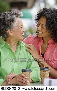 Stock Photo - african american 
mother and adult 
daughter smiling 
at each other. 
fotosearch - search 
stock photos, 
pictures, images, 
and photo clipart