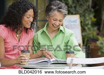 Stock Photo - african american 
mother and adult 
daughter looking 
at photo album. 
fotosearch - search 
stock photos, 
pictures, images, 
and photo clipart
