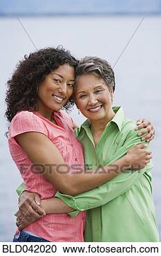 Stock Photography - african american 
mother and adult 
daughter hugging. 
fotosearch - search 
stock photos, 
pictures, images, 
and photo clipart