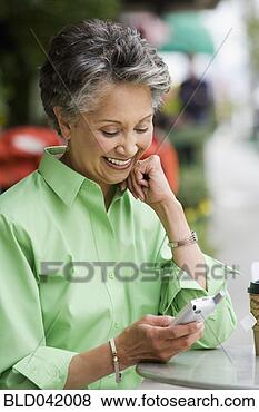 Stock Photo - african american 
woman looking 
at cell phone. 
fotosearch - search 
stock photos, 
pictures, images, 
and photo clipart