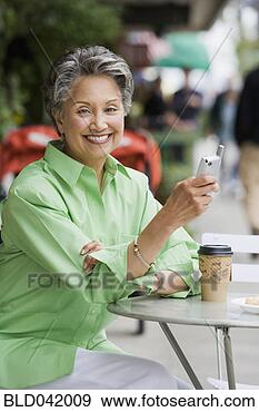 Stock Photograph - african american 
woman holding 
cell phone. fotosearch 
- search stock 
photos, pictures, 
images, and photo 
clipart