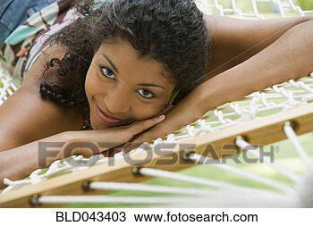 Stock Photo - african american 
woman laying in 
hammock. fotosearch 
- search stock 
photos, pictures, 
images, and photo 
clipart
