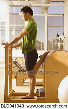 Stock Photo - asian man stretching 
on exercise equipment. 
fotosearch - search 
stock photos, 
pictures, images, 
and photo clipart