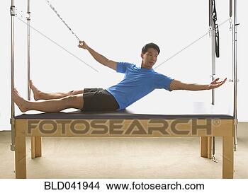 Stock Photo - asian man stretching 
on exercise equipment. 
fotosearch - search 
stock photos, 
pictures, images, 
and photo clipart