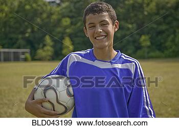 Stock Photograph - hispanic boy holding 
soccer ball. fotosearch 
- search stock 
photos, pictures, 
images, and photo 
clipart