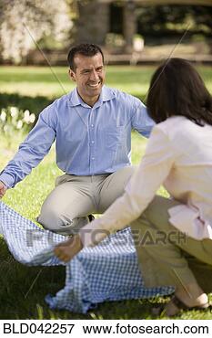 Picture - hispanic couple 
laying down picnic 
blanket. fotosearch 
- search stock 
photos, pictures, 
images, and photo 
clipart
