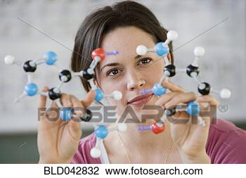 Stock Photo - hispanic woman 
holding molecular 
model. fotosearch 
- search stock 
photos, pictures, 
images, and photo 
clipart