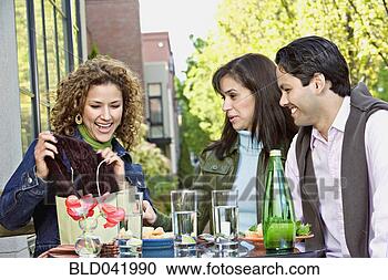 Stock Photography - hispanic woman 
showing friends 
new purchase. 
fotosearch - search 
stock photos, 
pictures, images, 
and photo clipart