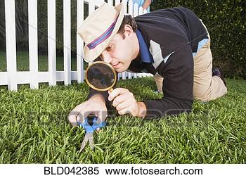 Stock Image - man cutting grass 
with scissors. 
fotosearch - search 
stock photos, 
pictures, images, 
and photo clipart