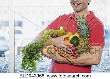 Stock Photo - man holding fresh 
fruit and vegetables 
at grocery store. 
fotosearch - search 
stock photos, 
pictures, images, 
and photo clipart