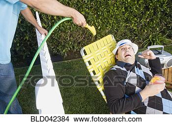 Stock Photo - man spraying neighbor 
with hose. fotosearch 
- search stock 
photos, pictures, 
images, and photo 
clipart