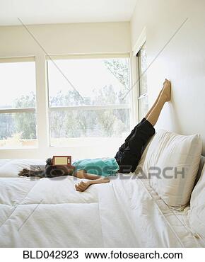 Stock Photo - middle eastern 
girl with book 
over face. fotosearch 
- search stock 
photos, pictures, 
images, and photo 
clipart