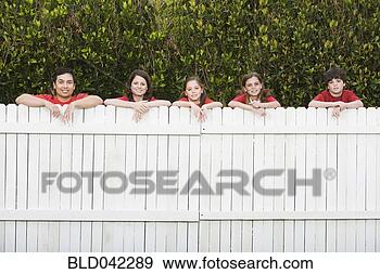 Stock Photograph - mixed race family 
leaning on fence. 
fotosearch - search 
stock photos, 
pictures, images, 
and photo clipart