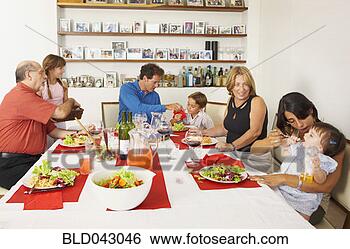 Stock Photo - multi-generational 
hispanic family 
eating dinner. 
fotosearch - search 
stock photos, 
pictures, images, 
and photo clipart