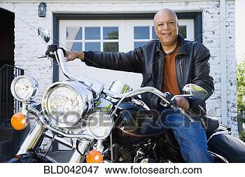 Picture - senior african 
american man sitting 
on motorcycle. 
fotosearch - search 
stock photos, 
pictures, images, 
and photo clipart