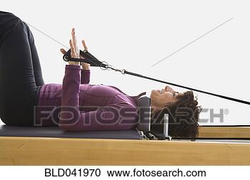 Stock Photography - senior woman stretching 
on exercise equipment. 
fotosearch - search 
stock photos, 
pictures, images, 
and photo clipart