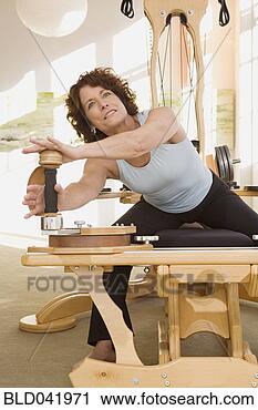Stock Photography - senior woman stretching 
on exercise equipment. 
fotosearch - search 
stock photos, 
pictures, images, 
and photo clipart