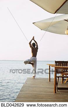 Stock Photograph - south american 
man practicing 
yoga. fotosearch 
- search stock 
photos, pictures, 
images, and photo 
clipart