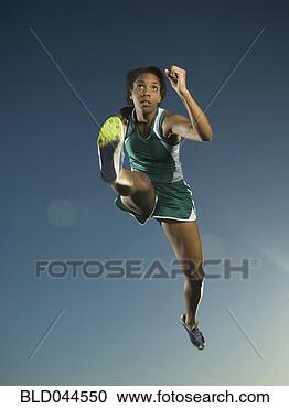 Stock Photography - african american 
female athlete 
jumping. fotosearch 
- search stock 
photos, pictures, 
images, and photo 
clipart