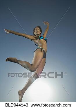 Stock Photo - african american 
woman in bathing 
suit jumping. 
fotosearch - search 
stock photos, 
pictures, images, 
and photo clipart